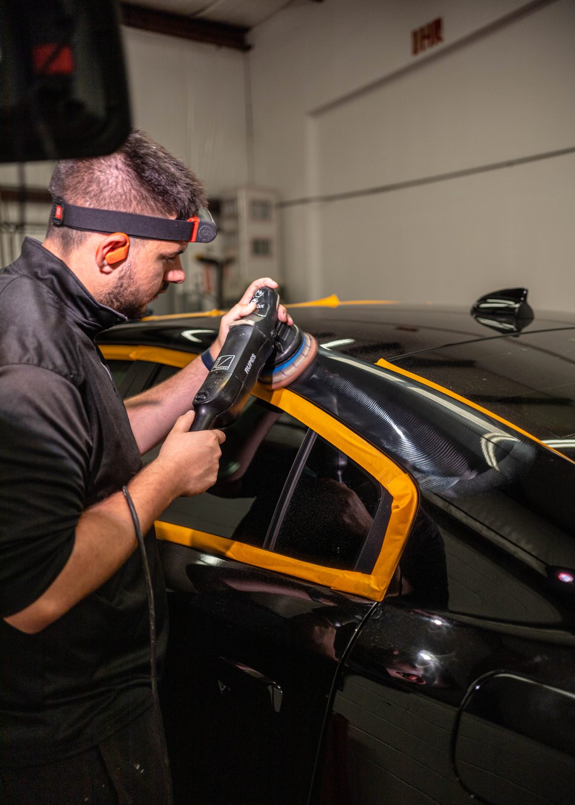 Obsidian detailer applying paint protection film to a hood in Chapel Hill