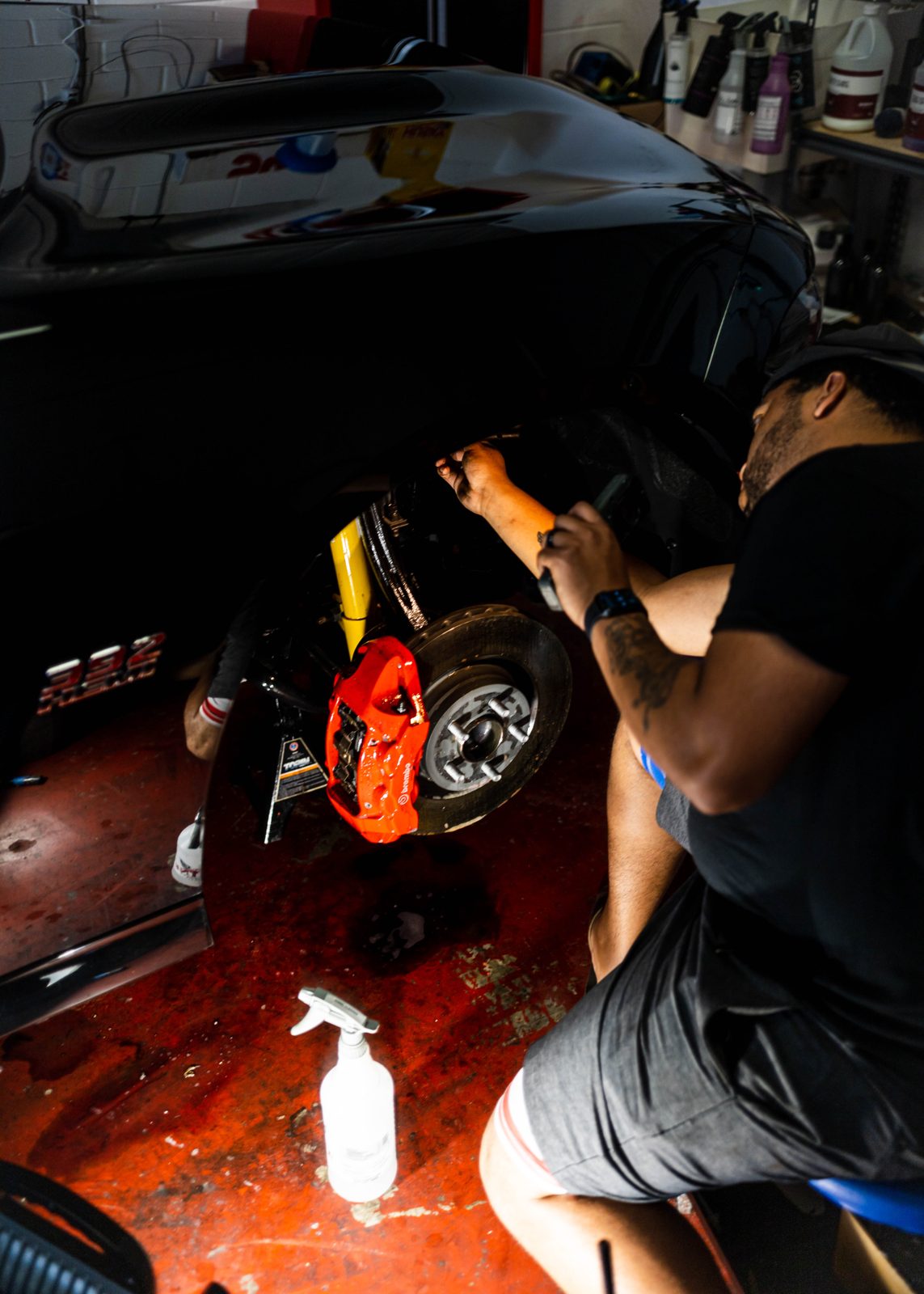 Obsidian detailer cleaning an engine bay during a mobile detail in Durham