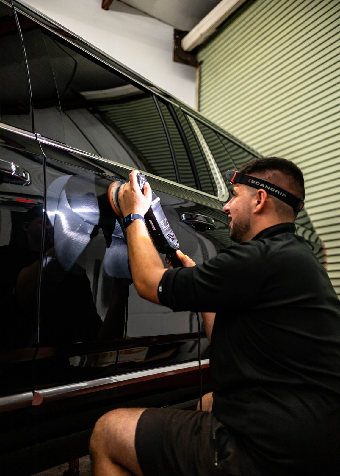 Obsidian detailer polishing a black SUV in Durham, NC