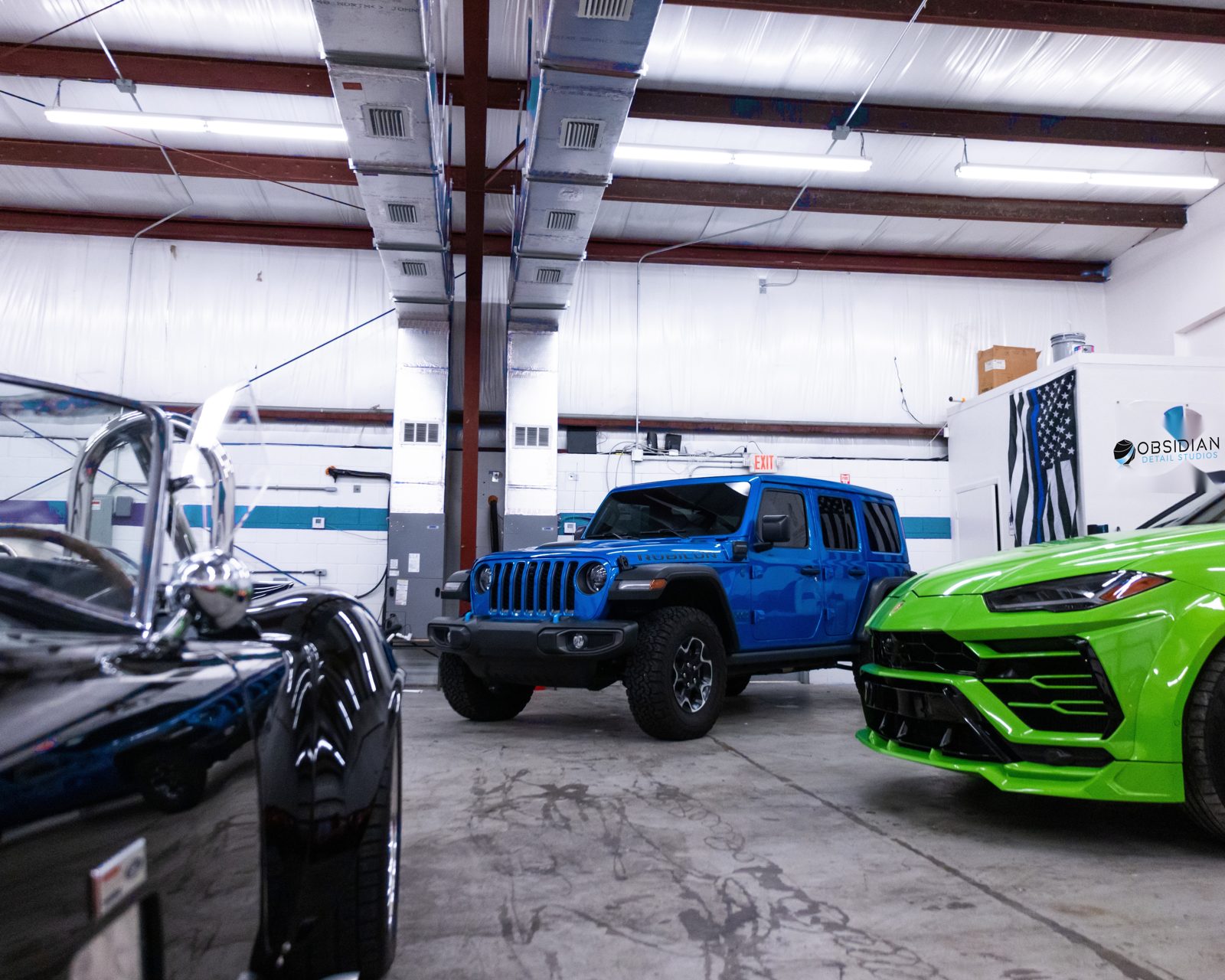 Lifted work truck being detailed on-site for a Durham fleet